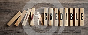 Pieces of wood with incredible and credible on wooden background photo