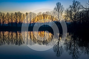 Piedmont, Italy, lakefront at sunset, in the park of the river po