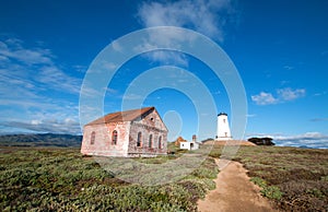 Piedras Blancas lighthouse and redbrick fog signal building on the Central California Coast north of San Simeon California