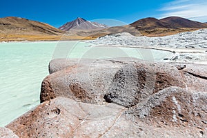 Piedras Rojas, volcano, snow, mountain, rocks, lake, white sand, turquoise water photo