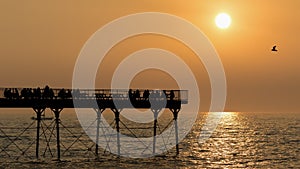 Aberystwyth Seafront on the coast to the Irish Sea with pier at sunset.