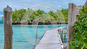 Pier of Bamboo Huts, Kordiris Homestay, Palmtree in Front, Gam Island, West Papuan, Raja Ampat, Indonesia