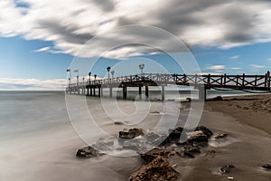 Pier on a beach in Marbella, Spain.