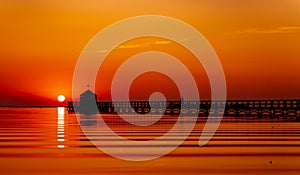 Pier on a beach by sunset