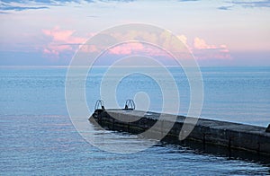 Pier, blue sky and sea on sunset