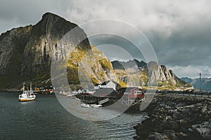 Pier with boats in the city of Reine Norway Lofoten Islands in autumn