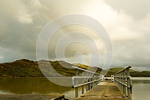 Pier or bridge at the lake, view on the mountain