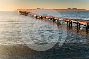 Pier and calm sea in sunset light