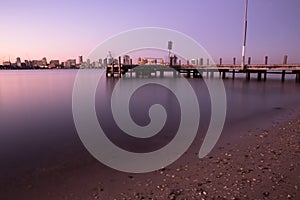 Pier and city skyline at night