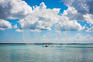 Pier with clouds and blue water at the Laguna Bacalar, Chetumal, Quintana Roo, Mexico.