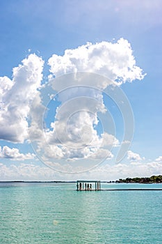 Pier with clouds and blue water at the Laguna Bacalar, Chetumal, Quintana Roo, Mexico.