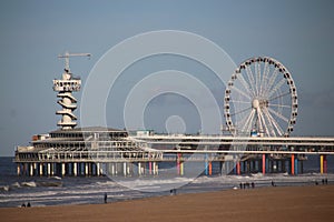 Pier and Ferris wheel at the beach of Scheveningen close to The Hague on the North sea beach.