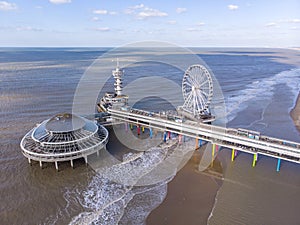 Pier with Ferris Wheel at Northern Sea Scheveningen Beach , located near the Hague city aerial drone footage. Popular