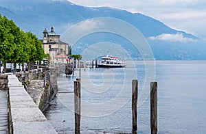 The pier with a ferry boat in Cannobio on the lake Maggiore in Piedmont, Italy