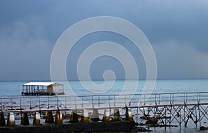 Pier and float storm clouds