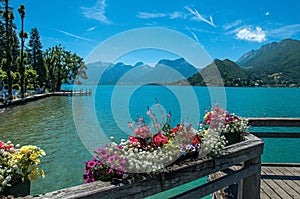Pier with flowers on the lake of Annecy, in the village of Talloires.