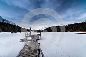 Pier on frozen lake