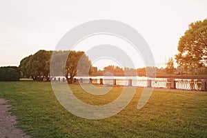 Pier with green grass near bay in susnset light vyborg