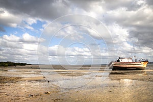 The pier in the harbour of Inhambane with old boats