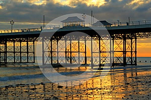 Pier or jetty, colourful sunrise. Cromer. UK.