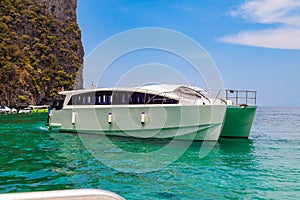 Pier or jetty on phi phi leh island in krabi in thailand near maya bay with boats and tourists on a hot sunny day. Travel and