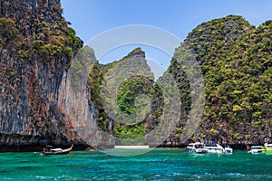 Pier or jetty on phi phi leh island in krabi in thailand near maya bay with boats and tourists on a hot sunny day. Travel and