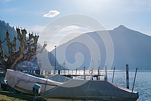 Pier of the Lake Ceresio of village Bissone near Lugano on a sunny day. Canton Ticino. Switzerland