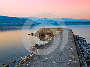 Pier at the lake Murtensee at sunset