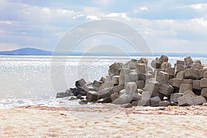 pier with large shaped stones near the beach. background, nature, landscape