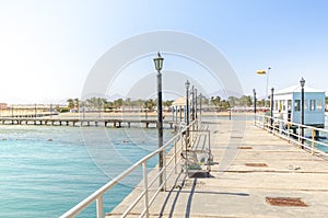 Pier leading to the sea on a sunny day/empty pier overlooking the sea on a sunny day