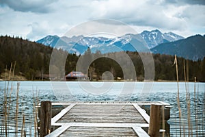 A pier leads out to the Lautersee near Mittenwald in the Bavarian Alps