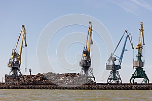On the pier lies a large pile of metal scrap intended for loading into the vessel by using cranes