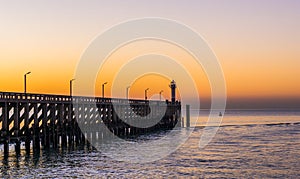 The pier with light house in Blankenberge, Belgium, Sunset at sea
