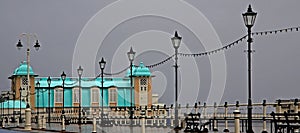 Pier lit up against grey sky