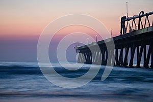 Pier near the calm sea under the beautiful sunset sky