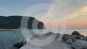 Pier in the park of Mount Conero, beach Urbani at sunrise, Marche region, Italy