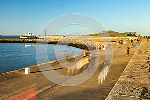 Pier promenade and lighthouse at sunset. Howth. Dublin. Ireland