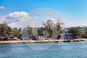 Pier Rawai beach in thailand on the island of phuket with old fishing wooden boats with long ropes moored to the shore