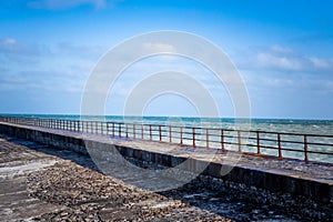 Pier with rusty grate on the sea. North coast