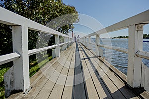 On a pier by the sea. couple outdoors. mixed pair of lovers, African man and European Caucasian woman.