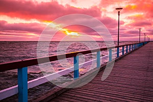 Pier and sea at sunset photo