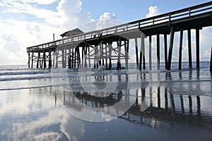 The pier sends a beautiful reflection to the beach floor