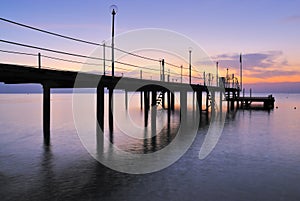 Pier silhouette over sunrise glow