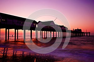 Pier silhouetted at sunset