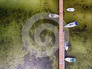 Pier with speed boats, marina lot. Aerial view from drone