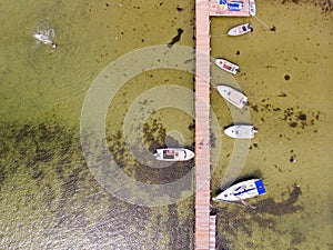 Pier with speed boats, marina lot, Skadovsk, Ukraine. People have fun in the water