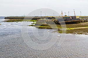 Pier with stucked boat in Corrib river photo