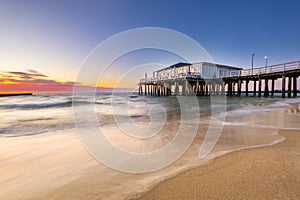 Pier sunset on the beach by the sea