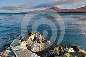 Pier to water's edge, overlooking the mountains of Jura