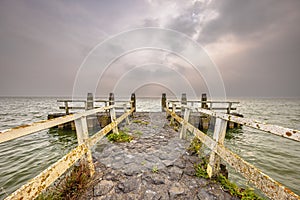 Pier in water of lake IJsselmeer